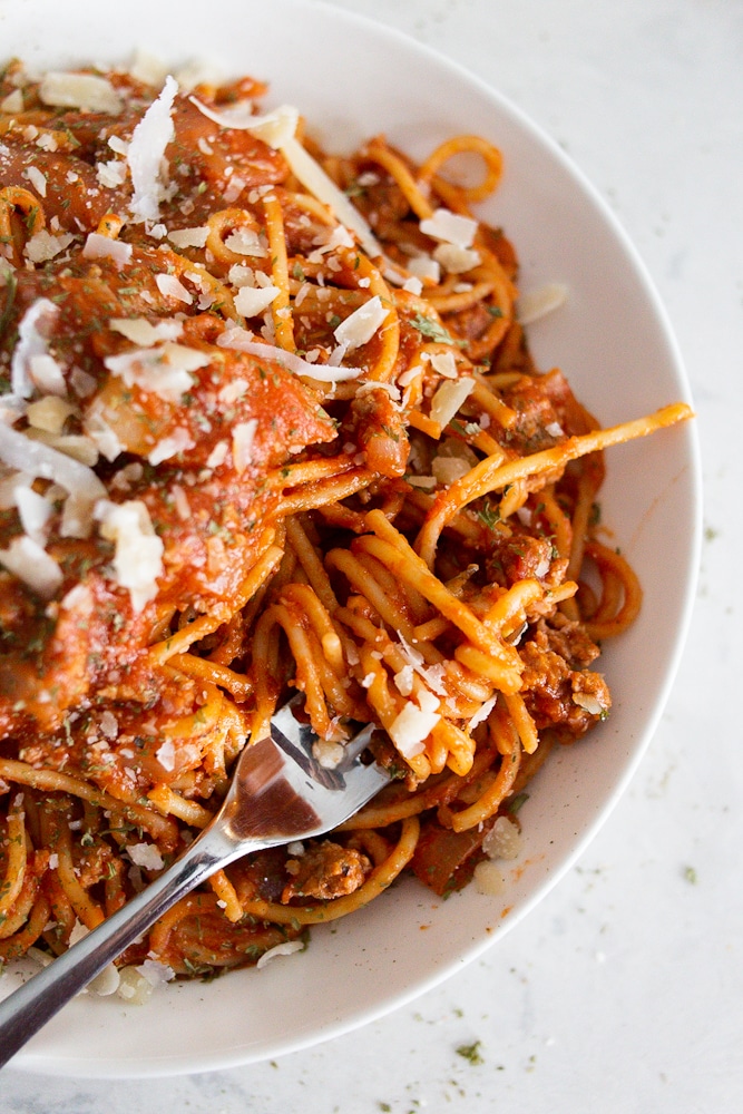 A bowl of one pan spaghetti with red meat sauce.