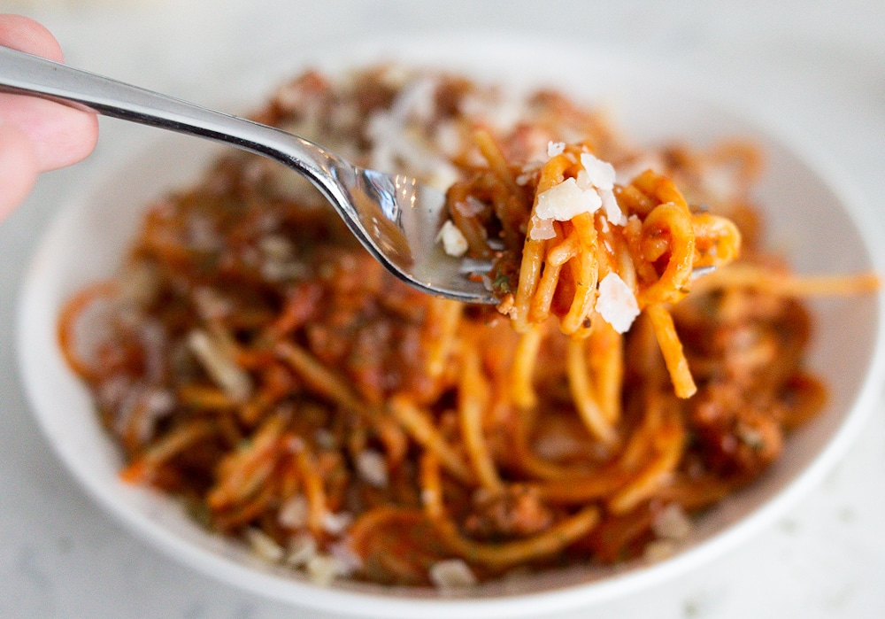 A bowl of one pan spaghetti with red meat sauce.