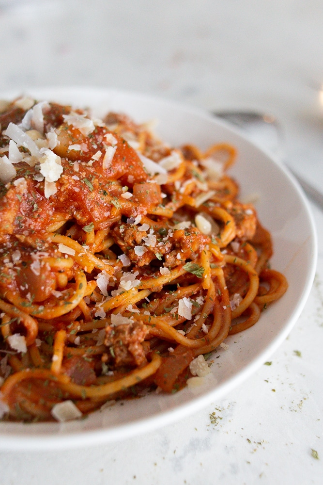 A bowl of one pan spaghetti with red meat sauce.